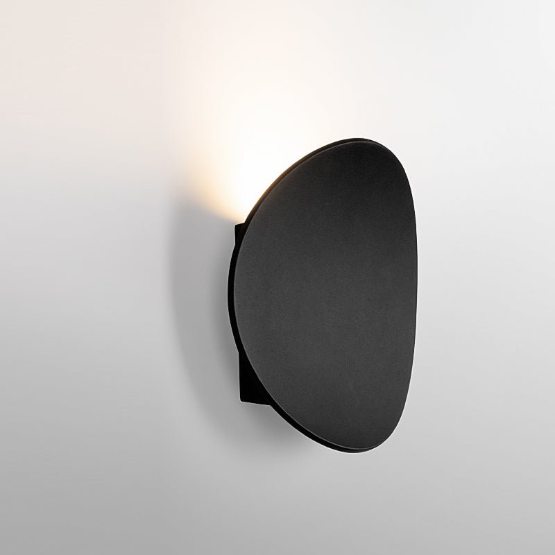 Camille round LED wall light – in black, lit side view