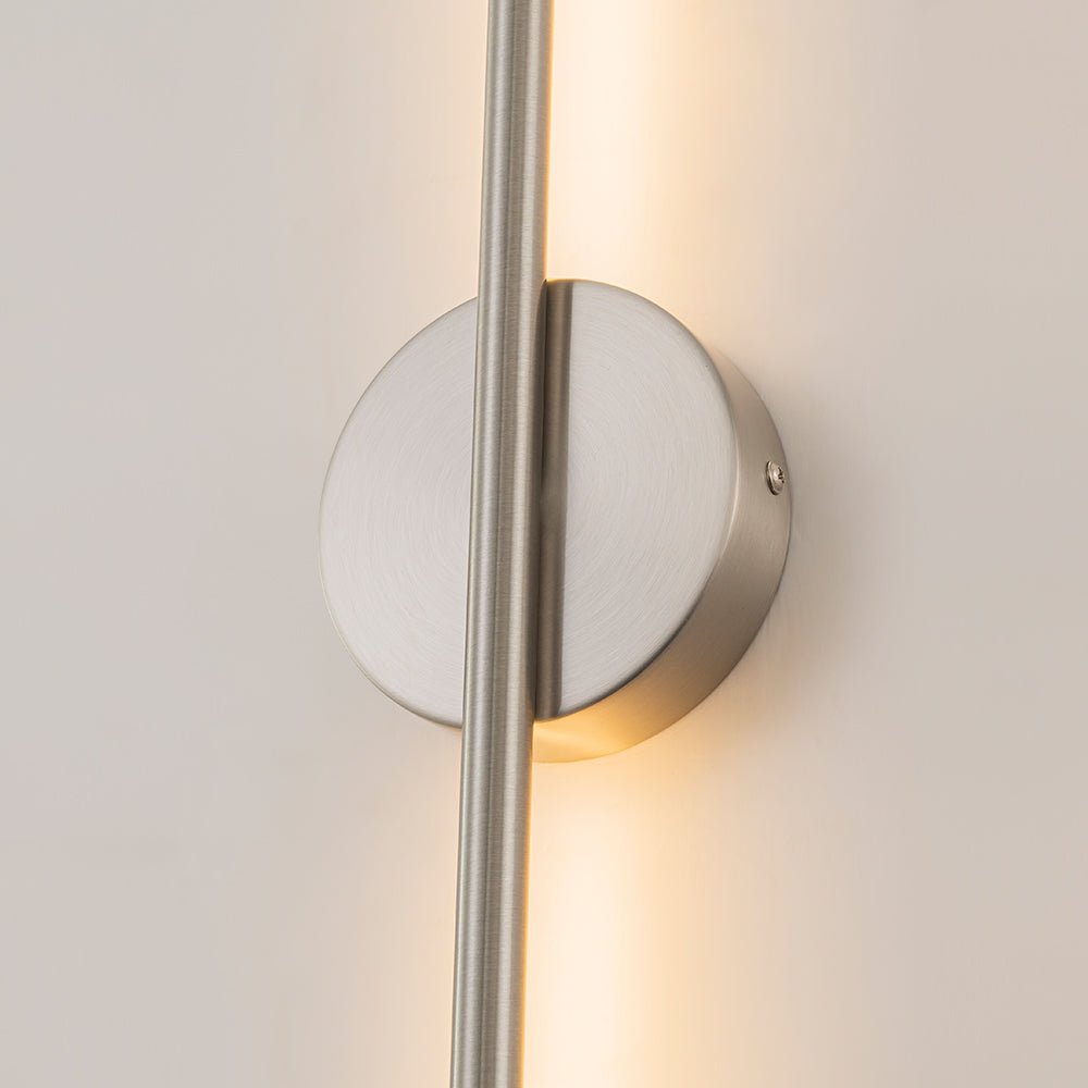Sebastian linear LED wall light – nickel wall disc, lit close-up