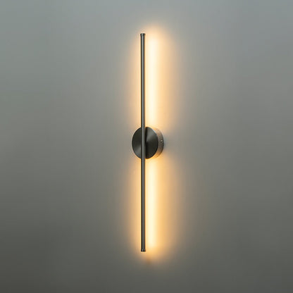 Sebastian linear LED wall light – in nickel, lit on a grey wall