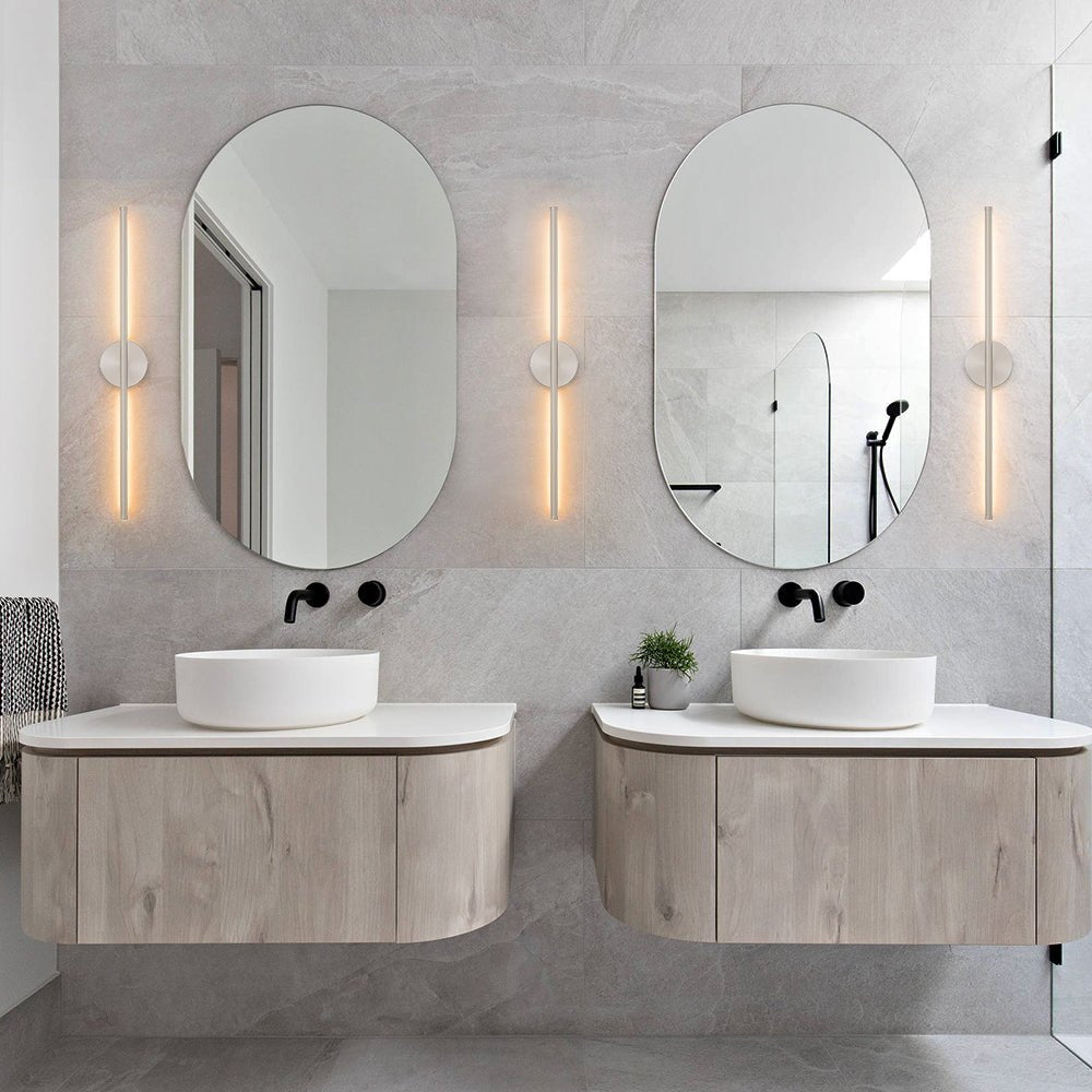 Sebastian linear LED wall light – pair beside oval mirrors