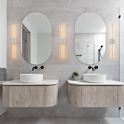 Sebastian linear LED wall light – pair beside oval mirrors