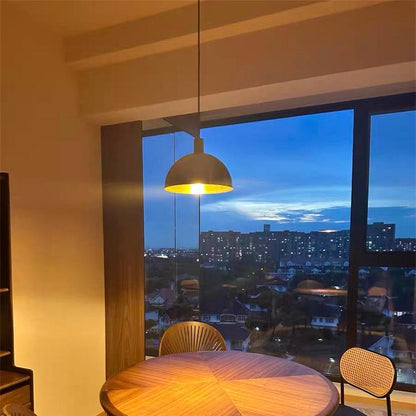 Vincenzo lipped dome pendant – by a window at dusk