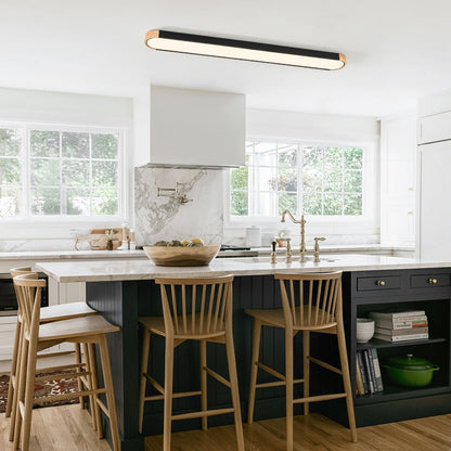 Imogen black 122 cm oval LED ceiling light above a kitchen island
