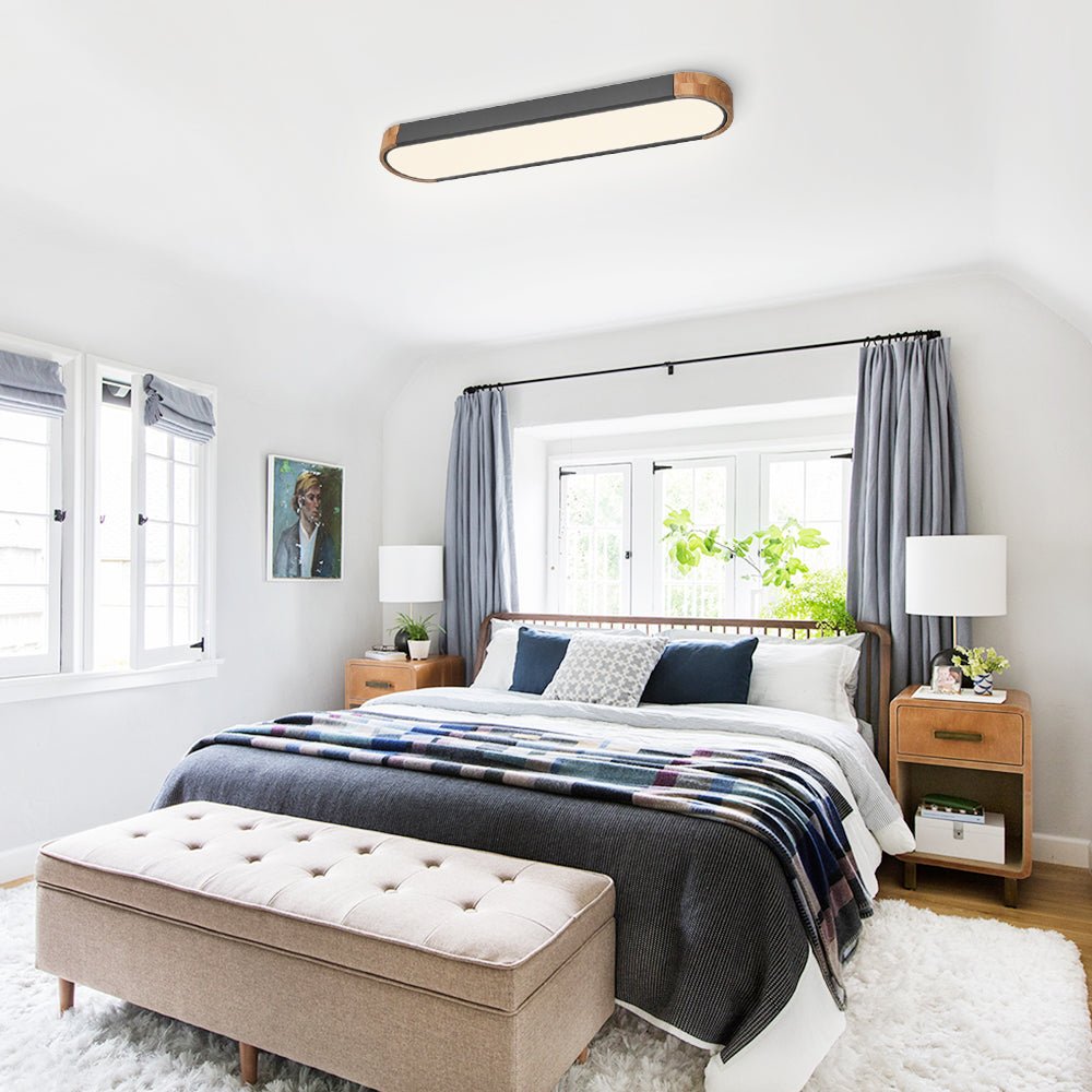 Imogen grey oval LED ceiling light in a bedroom