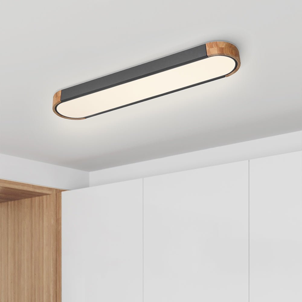 Imogen grey oval LED ceiling light on a white ceiling