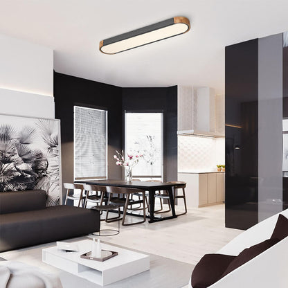 Imogen grey oval LED ceiling light in an open-plan dining area