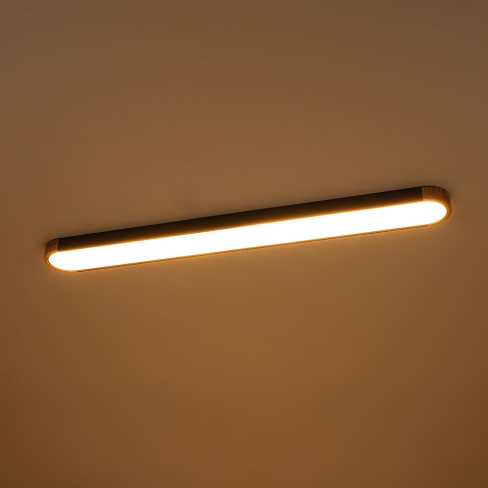 Imogen oval LED ceiling light switched on with warm white glow
