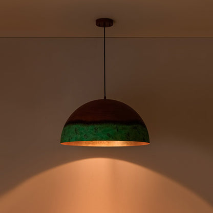 Caspian two-tone pendant – lit on a warm wall