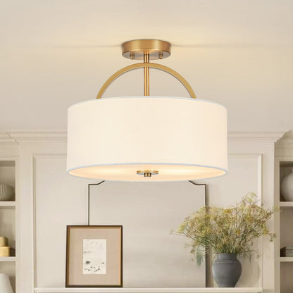 Isadora linen drum ceiling light – in brass by a window