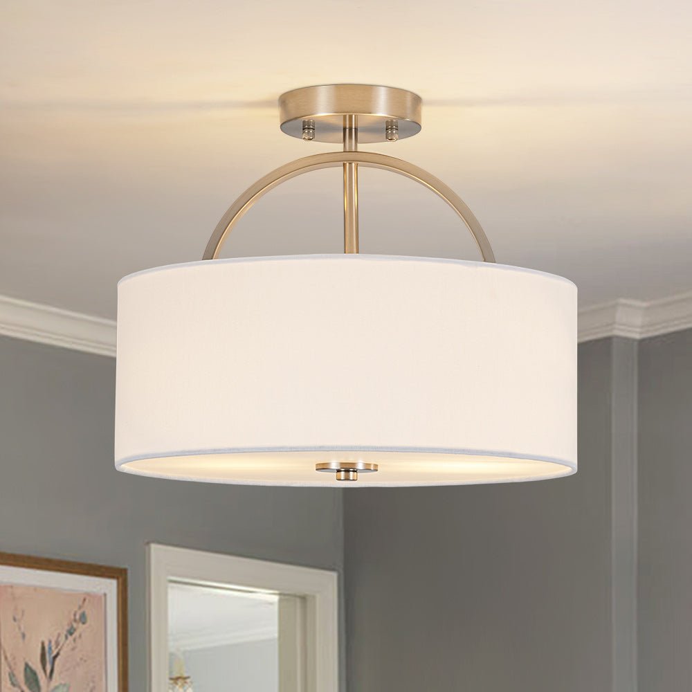Isadora linen drum ceiling light – in brass in a grey room