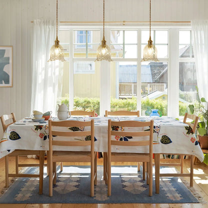 Rosalie flower glass pendant light – three in clear glass over a dining table