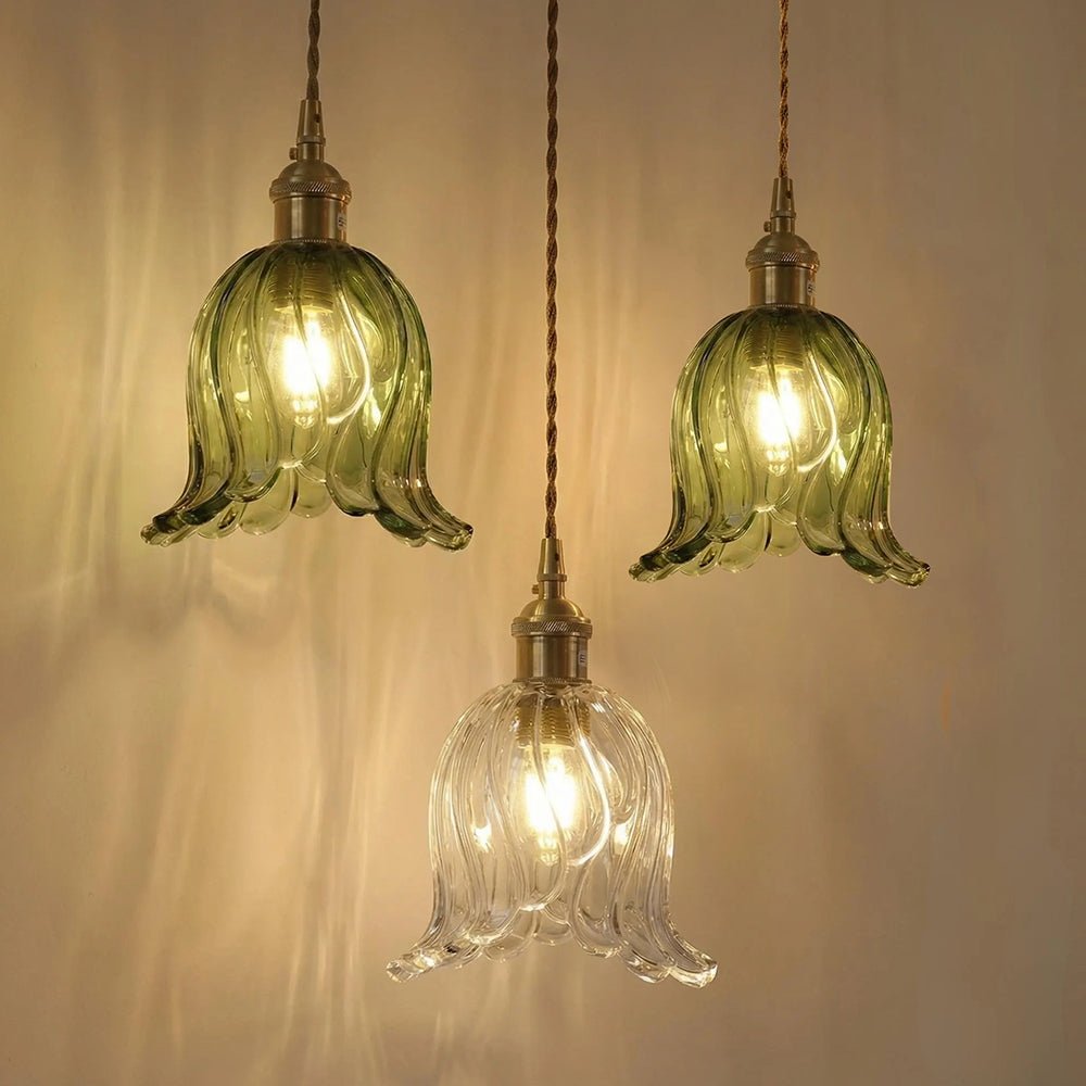 Rosalie flower glass pendant light – green and clear shades lit on a warm wall