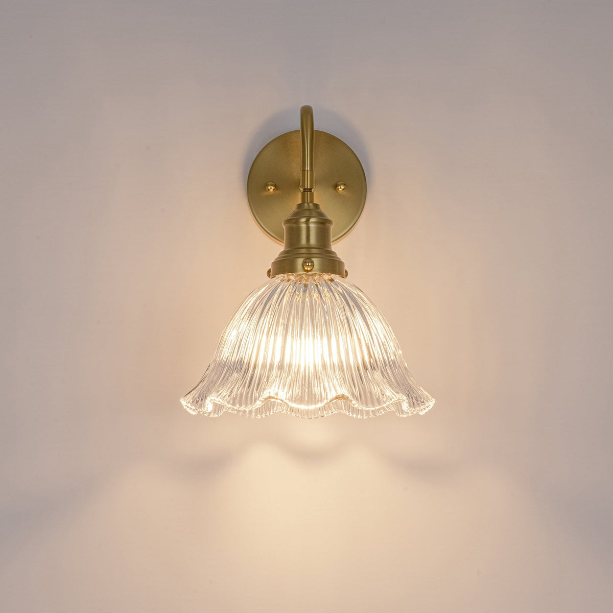 Fiorella flower wall light – lit on a wall