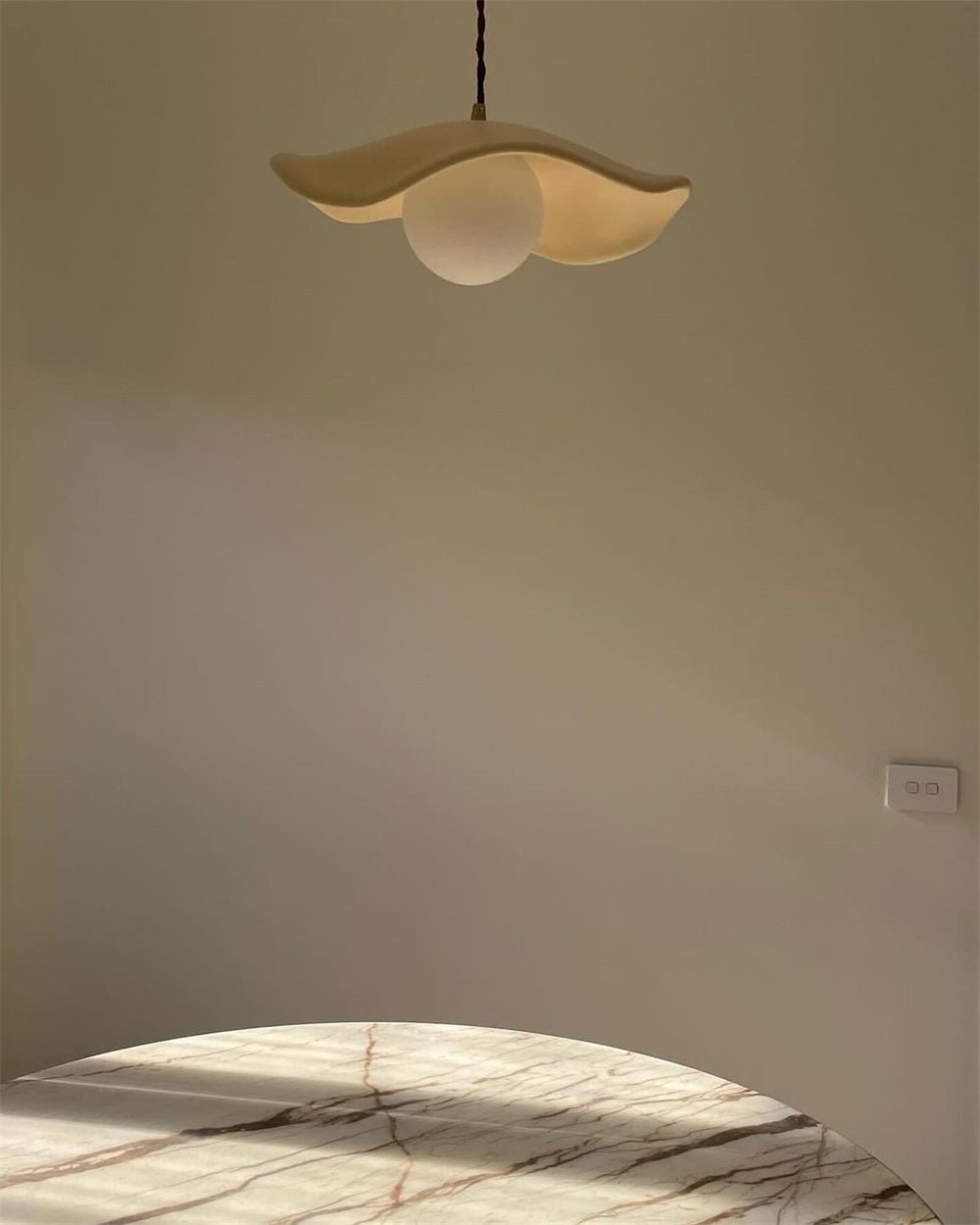 Giselle wavy resin pendant – lit, seen from below