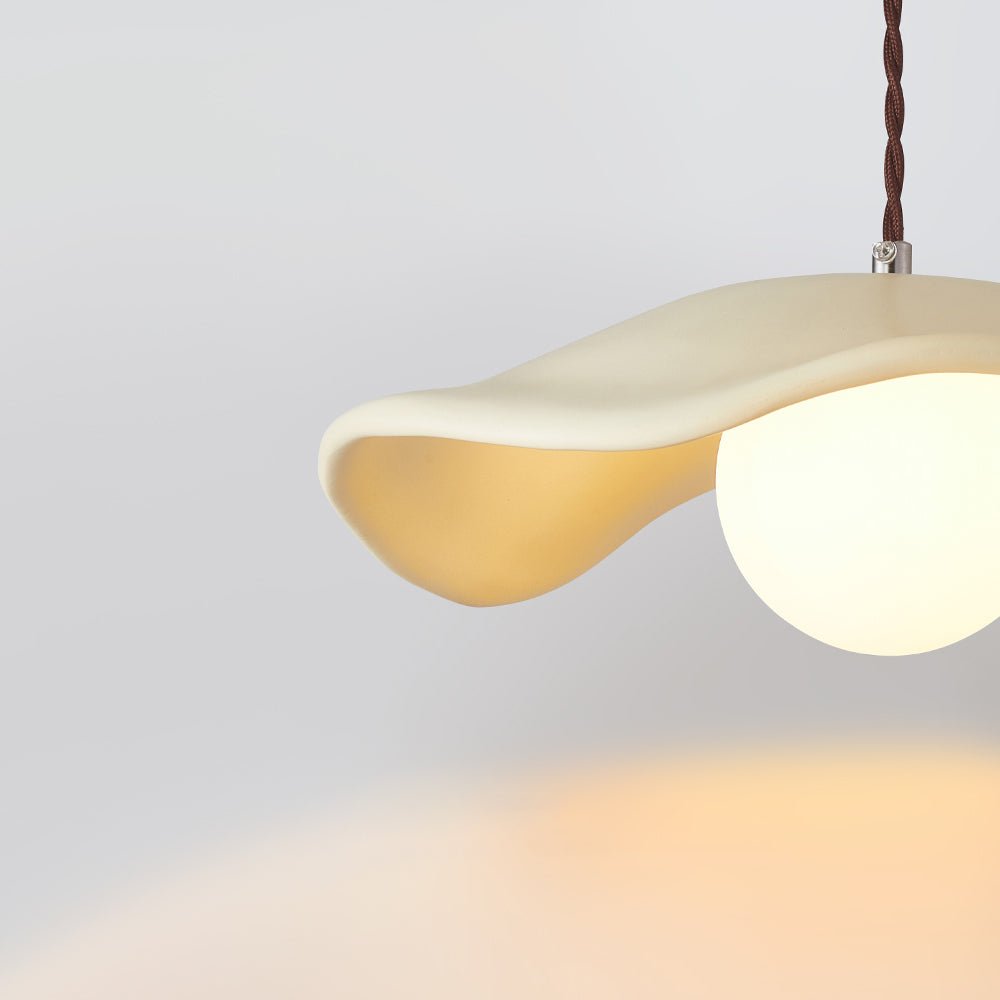 Giselle wavy resin pendant – beige shade lit, close-up