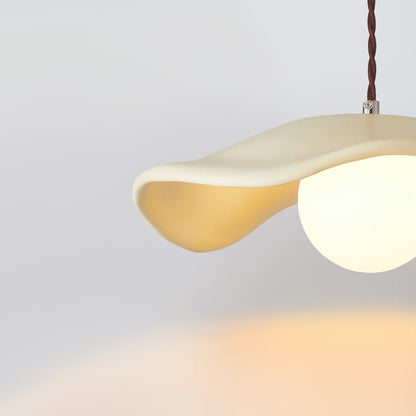 Giselle wavy resin pendant – beige shade lit, close-up